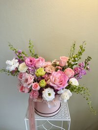 Pink and white rose bouquet with lilies and orchids in a decorative arrangement