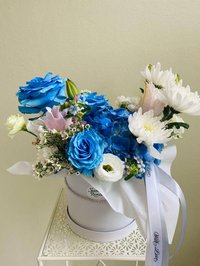Bouquet with blue roses, white chrysanthemums, and pink lilies in a white box