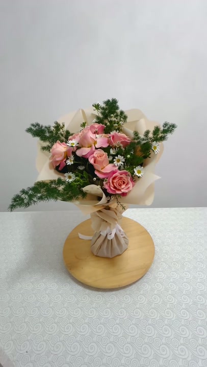 9 roses and aster in fine pine foliage