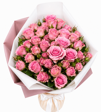 Pink rose bouquet elegantly wrapped with a ribbon.